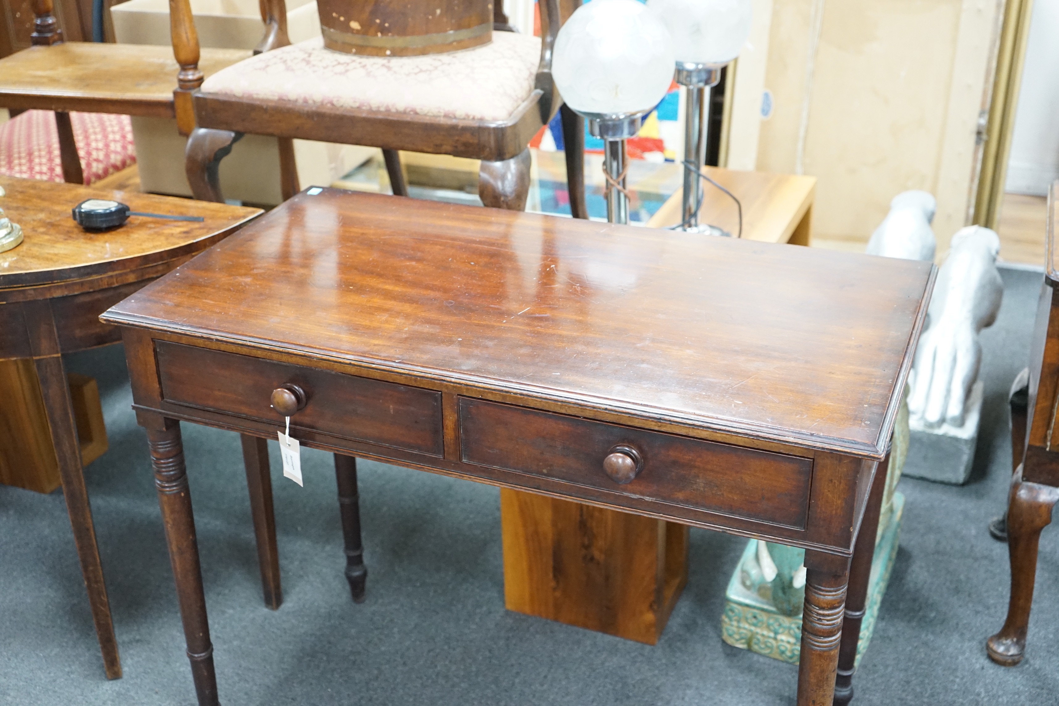 A Regency mahogany two drawer side table with moulded edge on turned legs, width 95cm, depth 51cm, height 78cm